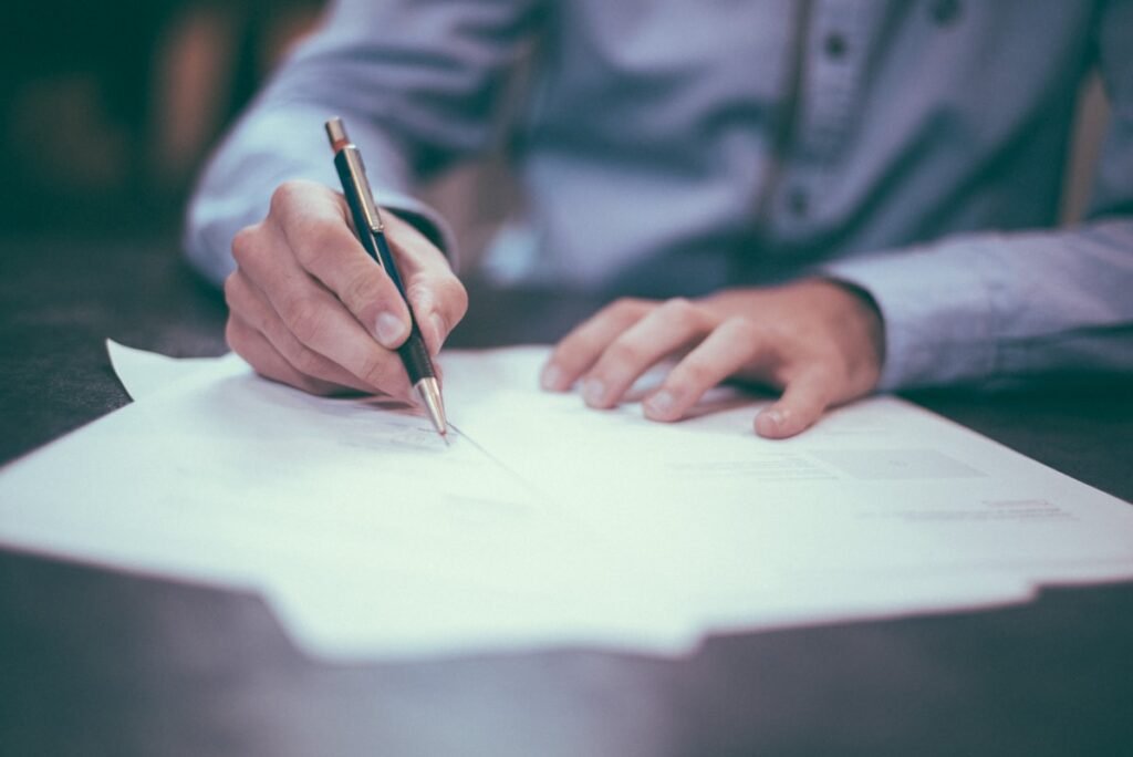 For the "Secure U.S. Immigration Settlements: 2026 Strategy Guide" featured image (showing the hand on a law book with a gavel), the alternative text should be:
